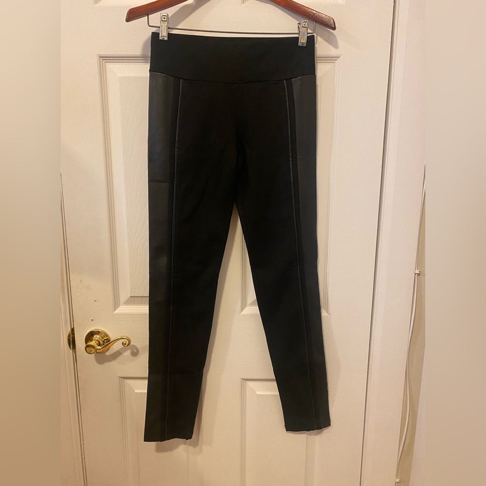 Sleek black Eaka leggings with tuxedo stripe down sides